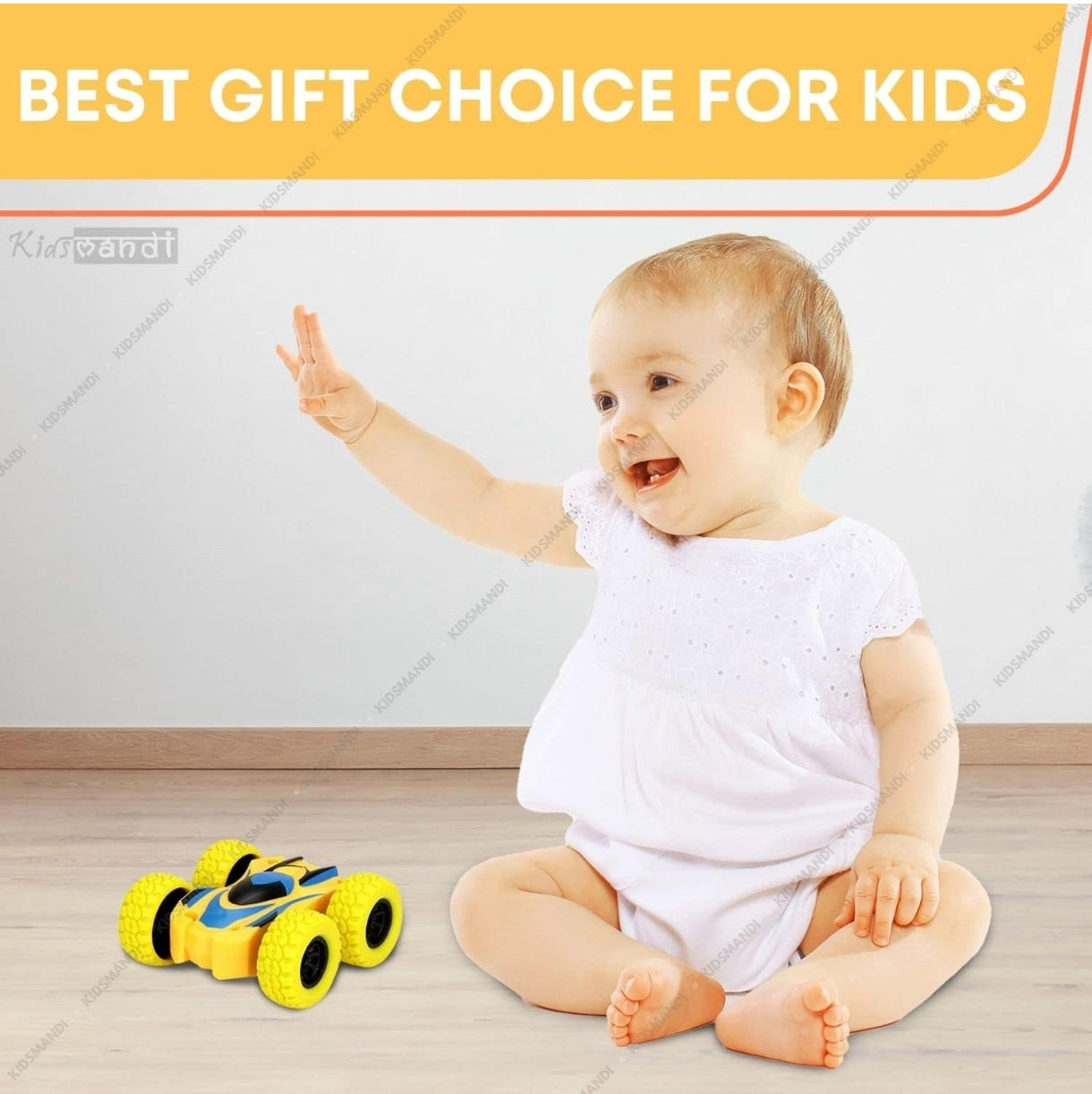 Baby playing with yellow and blue 360 degree stunt car toy on wooden floor