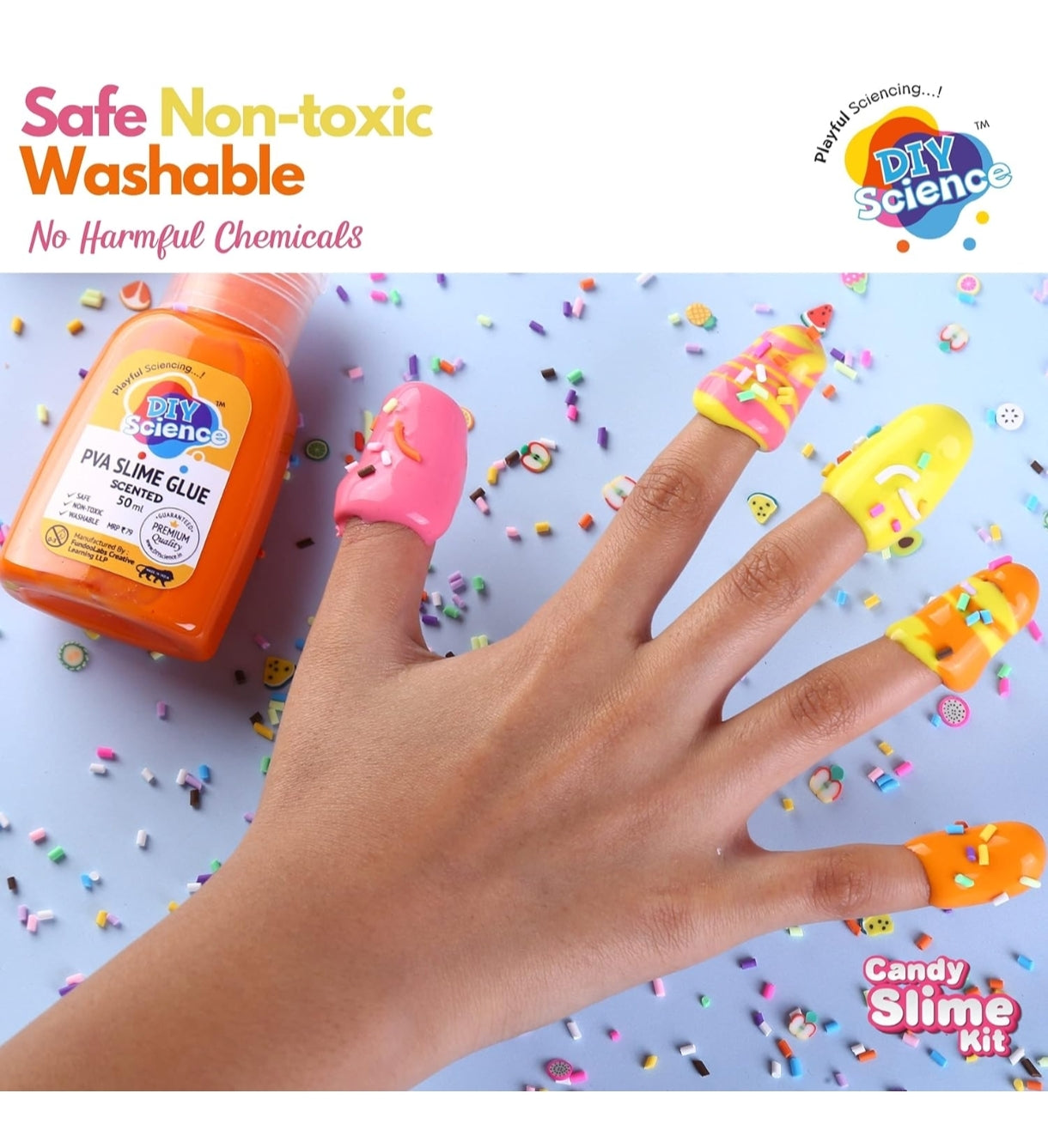 Hand with colorful slime on fingers next to a bottle of slime glue