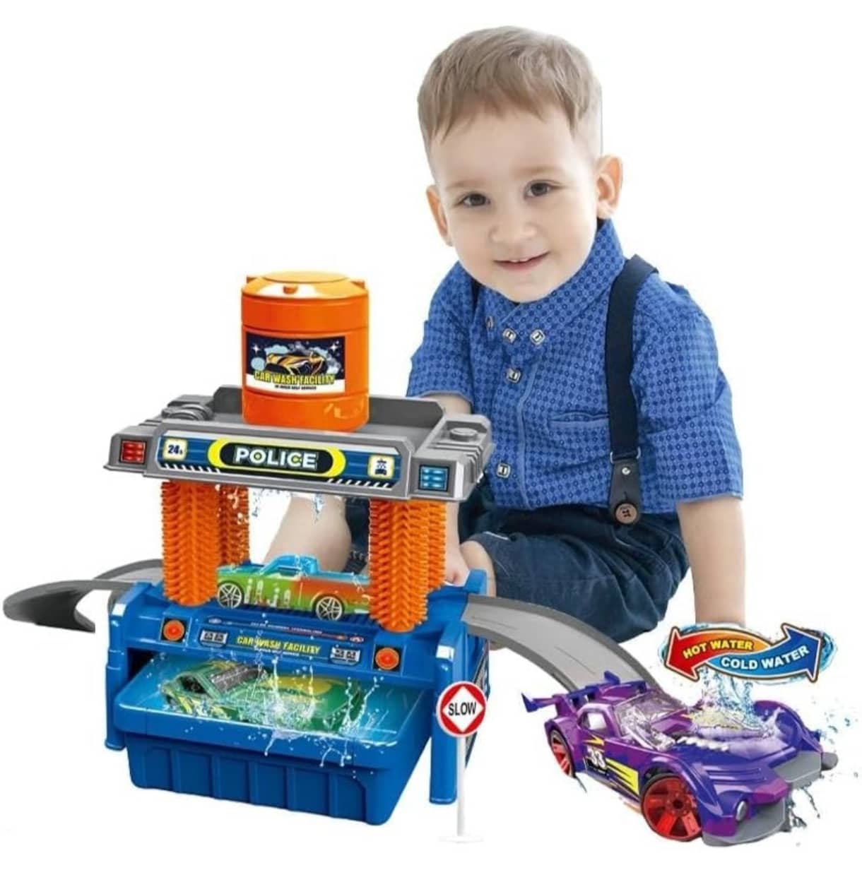 Child playing with a toy police station and cars on a white background