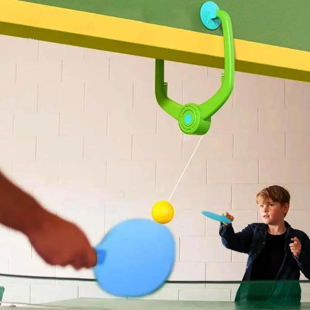 Interactive table tennis ping game setup with a yellow ball and paddles for kids