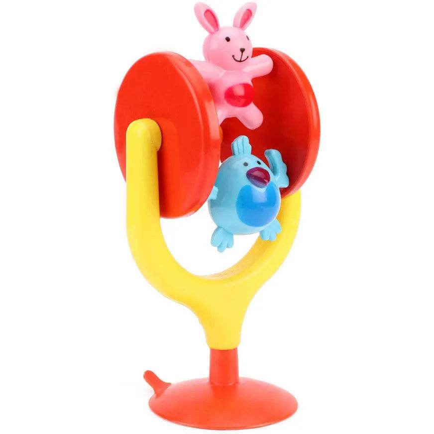 Colorful bunny merry go round toy for kids with pink bunny and blue bird on yellow and red base
