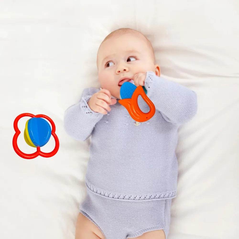 Baby lying down holding an orange and blue toy from the safari rattle set for babies by T-Rex the toyland Sitamarhi