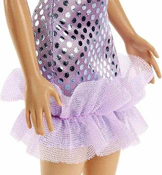 Close-up of Barbie doll with glitter dress showing shiny purple fabric and ruffled tulle skirt