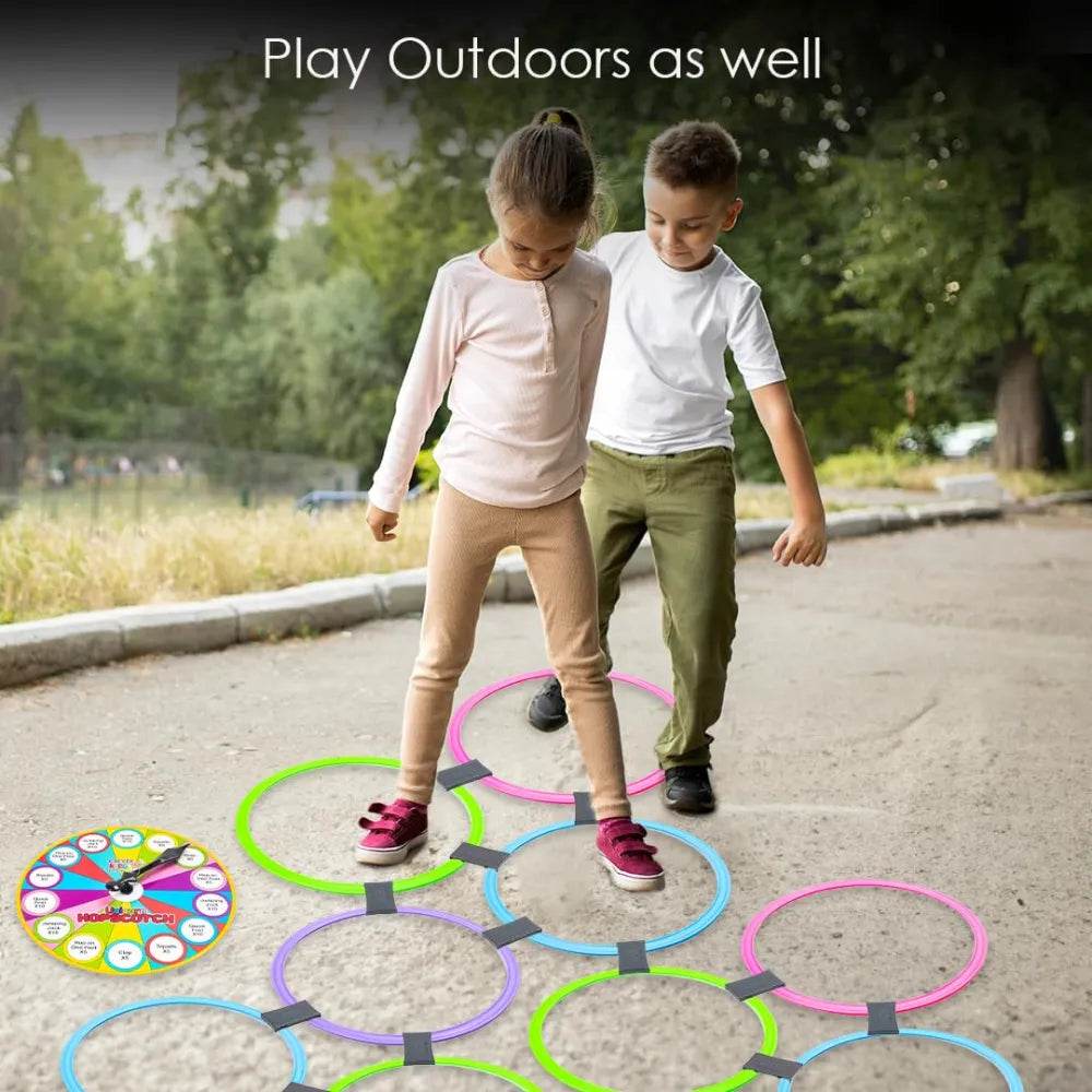 Two children playing with colorful rings and a spinner on pavement kids unicorn hopscotch set with spinner