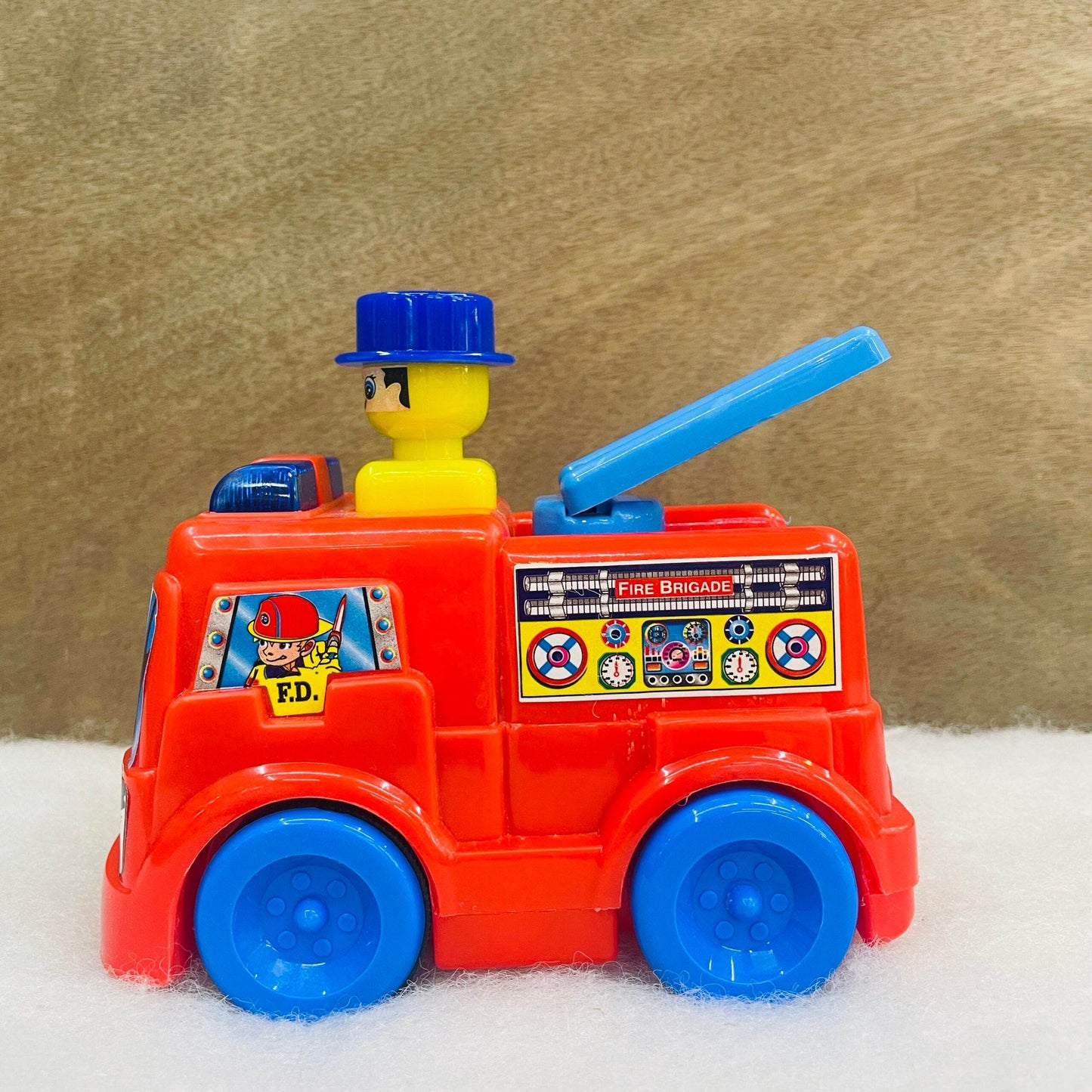Red and blue push and go fire truck toy with a firefighter figure and extendable ladder