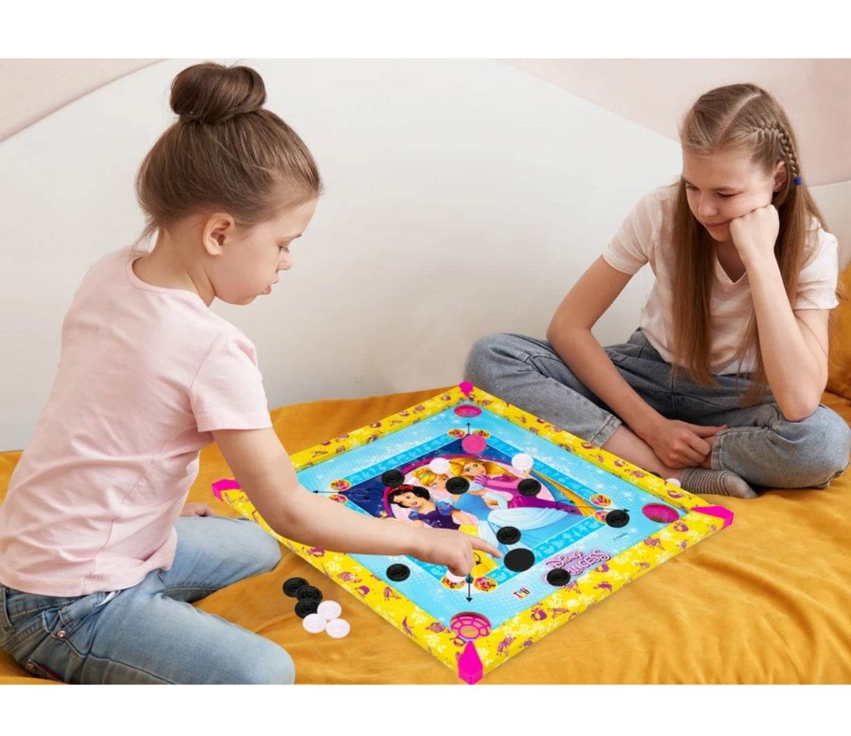 Children playing with colorful Disney Princess carrom board for kids on a yellow surface