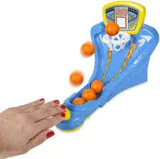 Toy basketball hoop with orange balls and a hand interacting with it on a white background