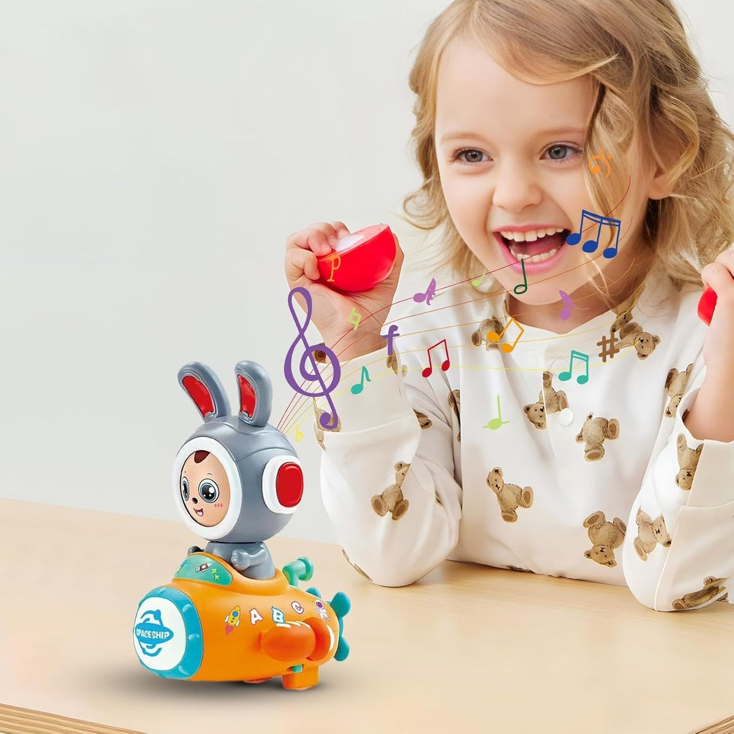 Girl playing with face changing rabbit musical toy by T-Rex the toyland Sitamarhi on wooden table