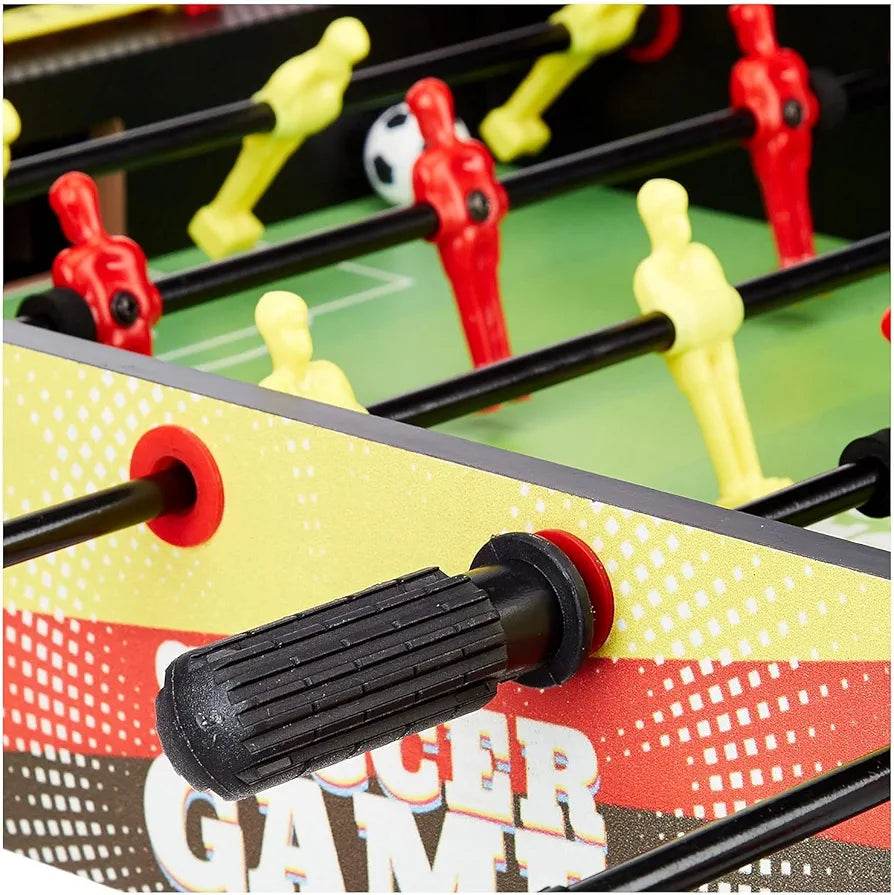 Close-up of a small foosball football board with red and yellow player figures and black handle grips