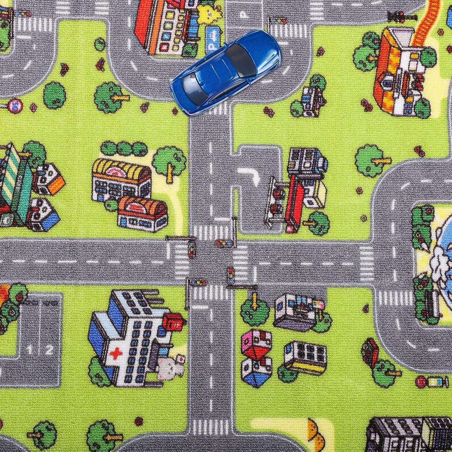 Unimats city road play mat for kids featuring roads, buildings, and a blue toy car on green background