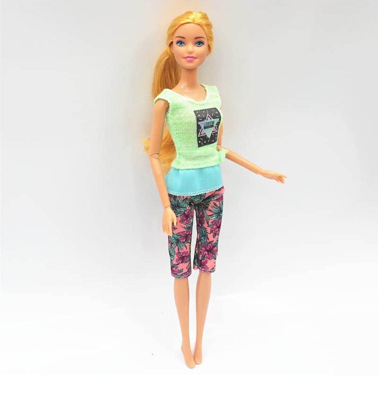Kiara fashion doll for kids wearing a green top and floral pants with blonde hair