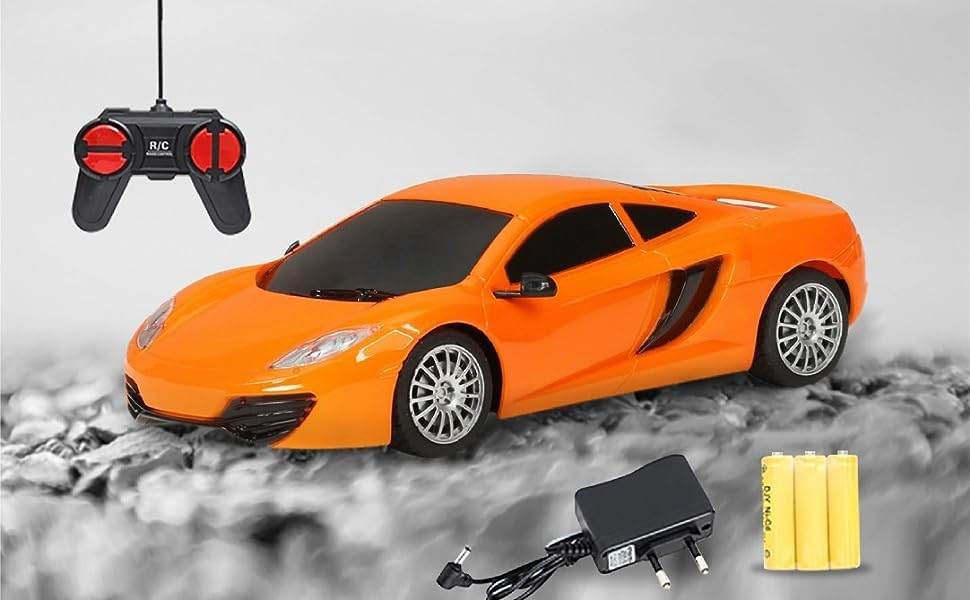 Orange remote control racing car with black remote, charger, and yellow batteries from T-Rex the toyland Sitamarhi