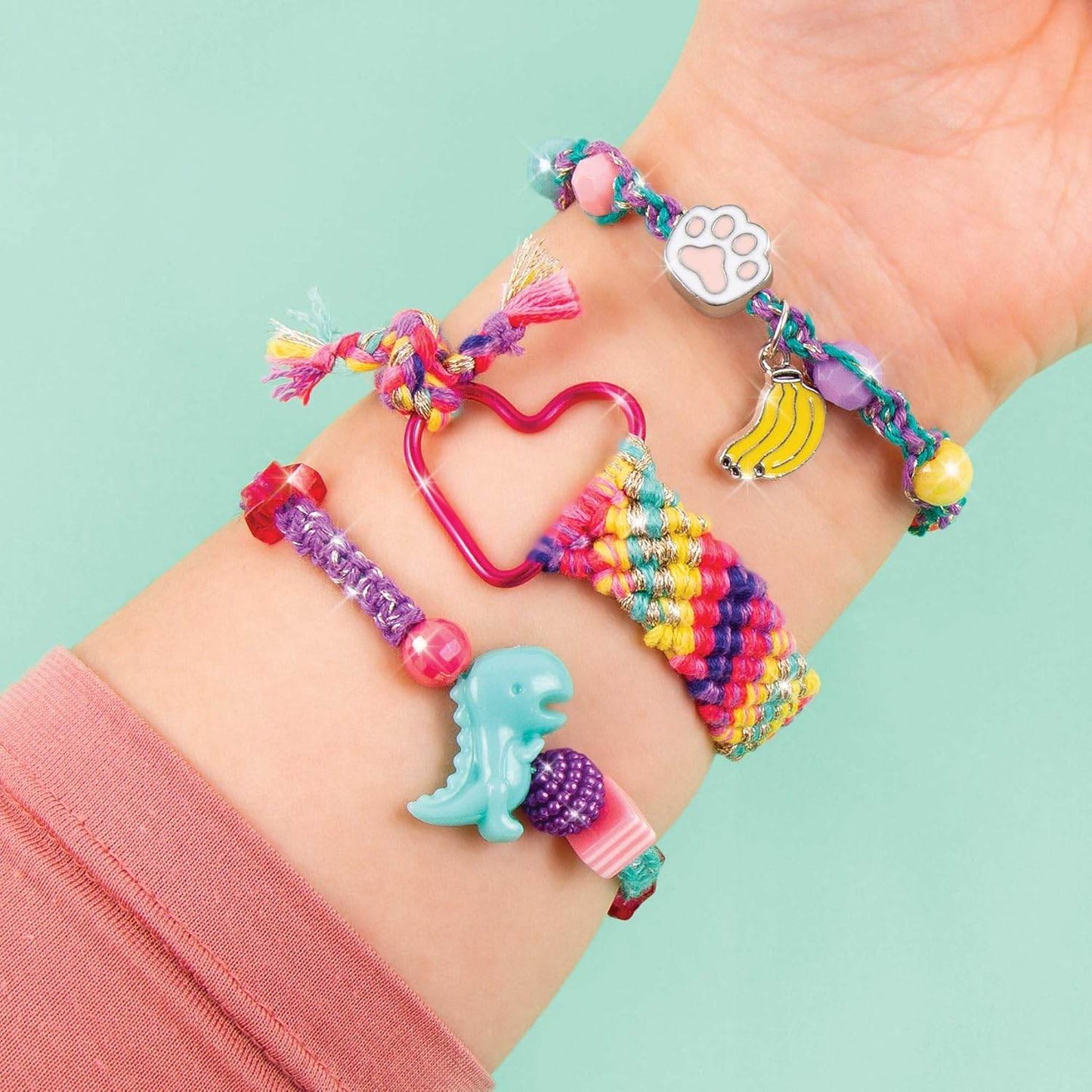 Colorful DIY charm bracelet kit for kids featuring fun charms like dinosaur, banana, and paw print on wrist
