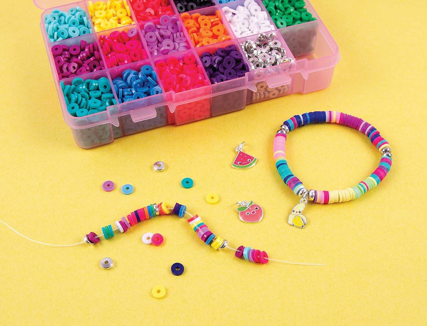 Heishi bead bracelet kit with colorful beads, charms, and a completed bracelet on a yellow background