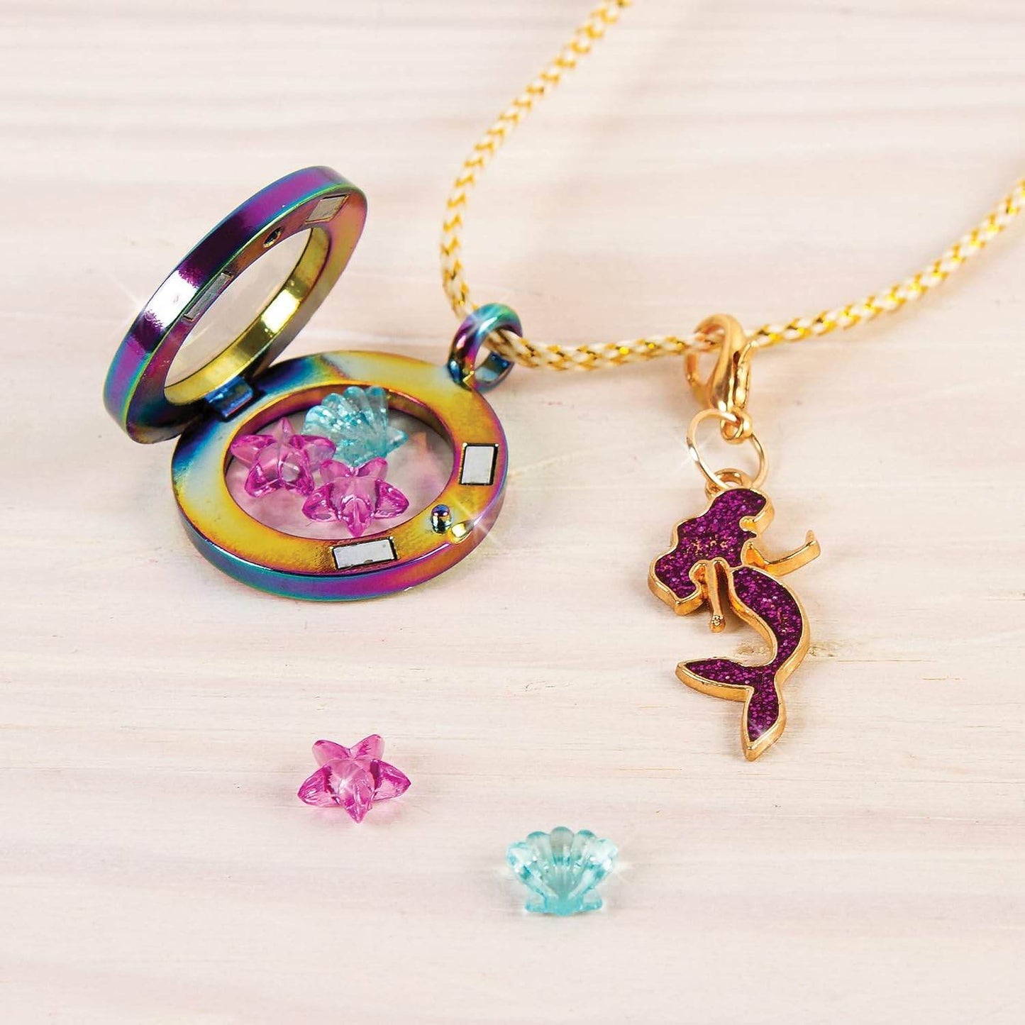 Make your own jewelry set with colorful mermaid pendant and charm pieces on a gold chain