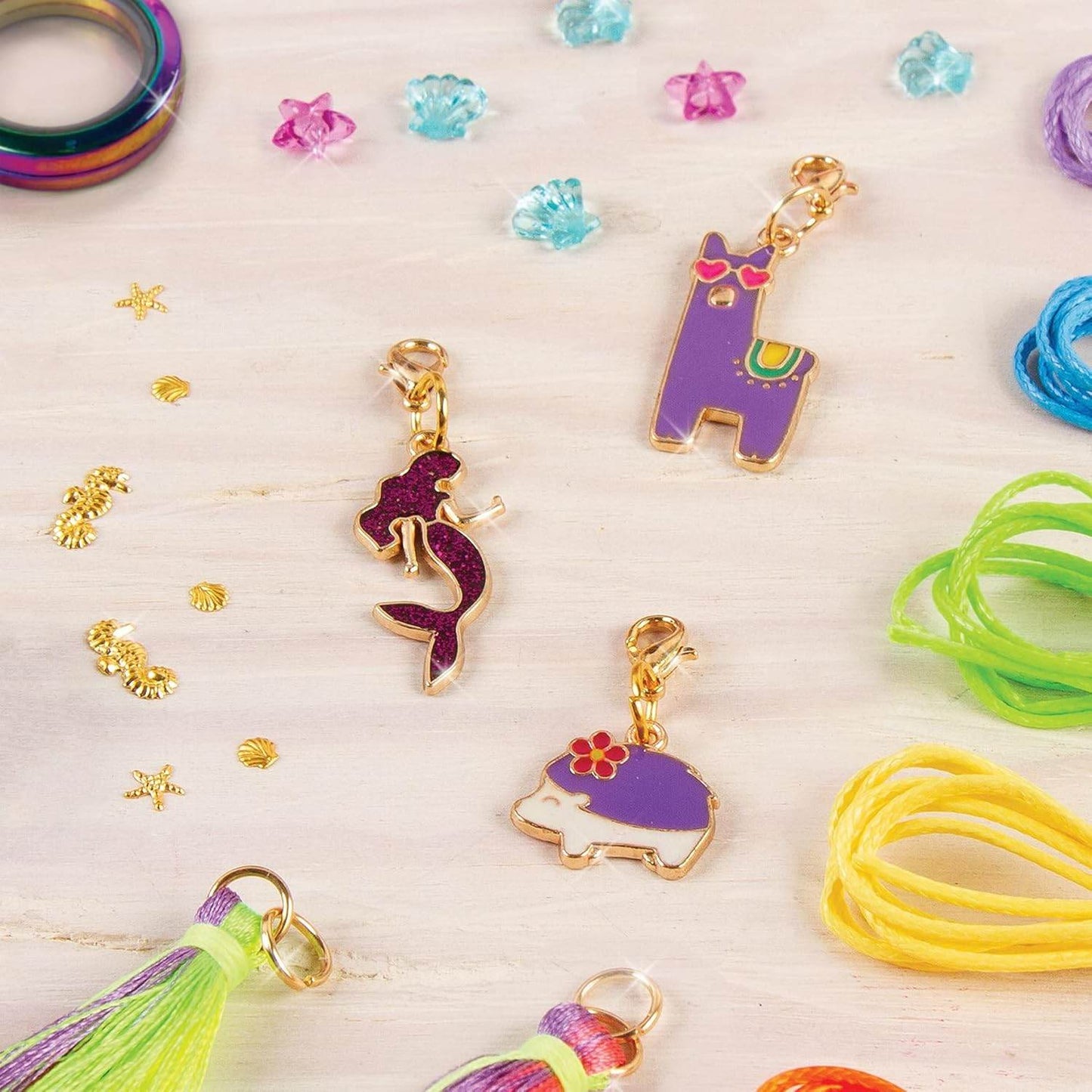 Make your own jewelry set with colorful charms including mermaid, llama, and turtle designs