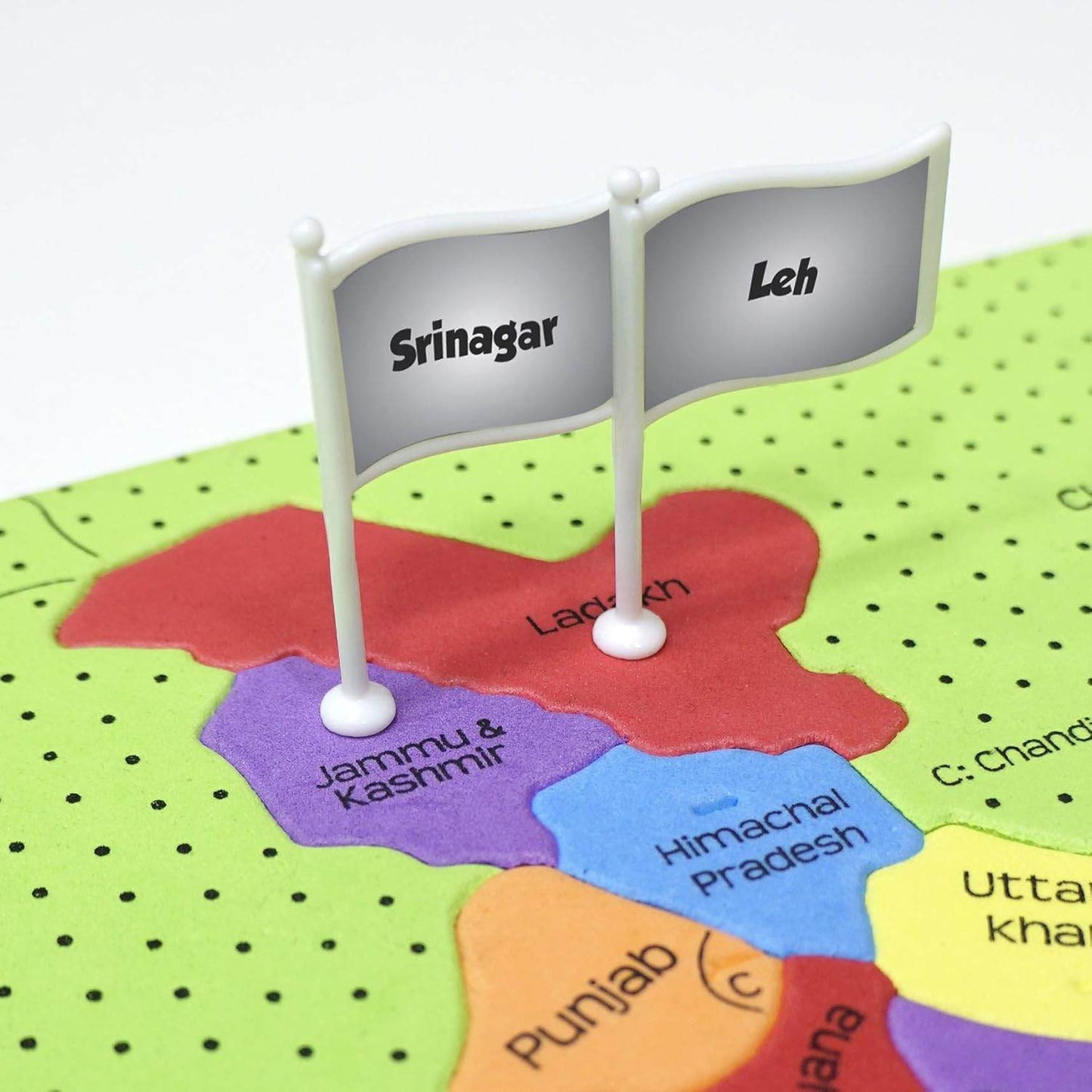 Close-up of colorful India map puzzle for kids showing Jammu Kashmir and Ladakh regions with flag markers