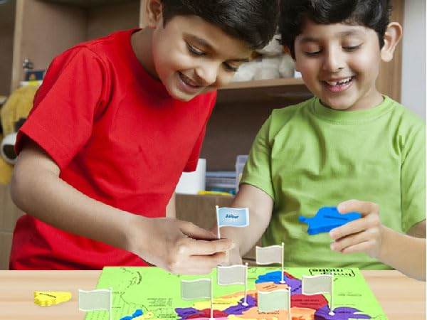 Two kids playing with colorful India map puzzle for kids on a table at home