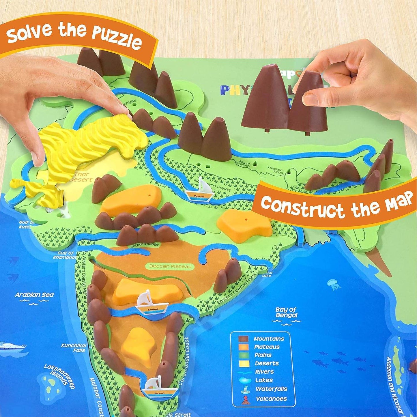 Hands assembling Mapology Physical Features of India puzzle showing mountains rivers plateaus and lakes