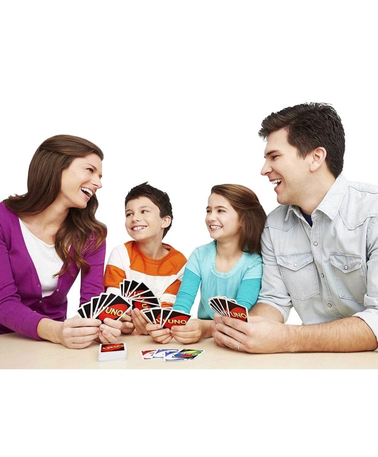 Family playing Mattel Uno card game 112 cards with colorful cards on table and smiling faces