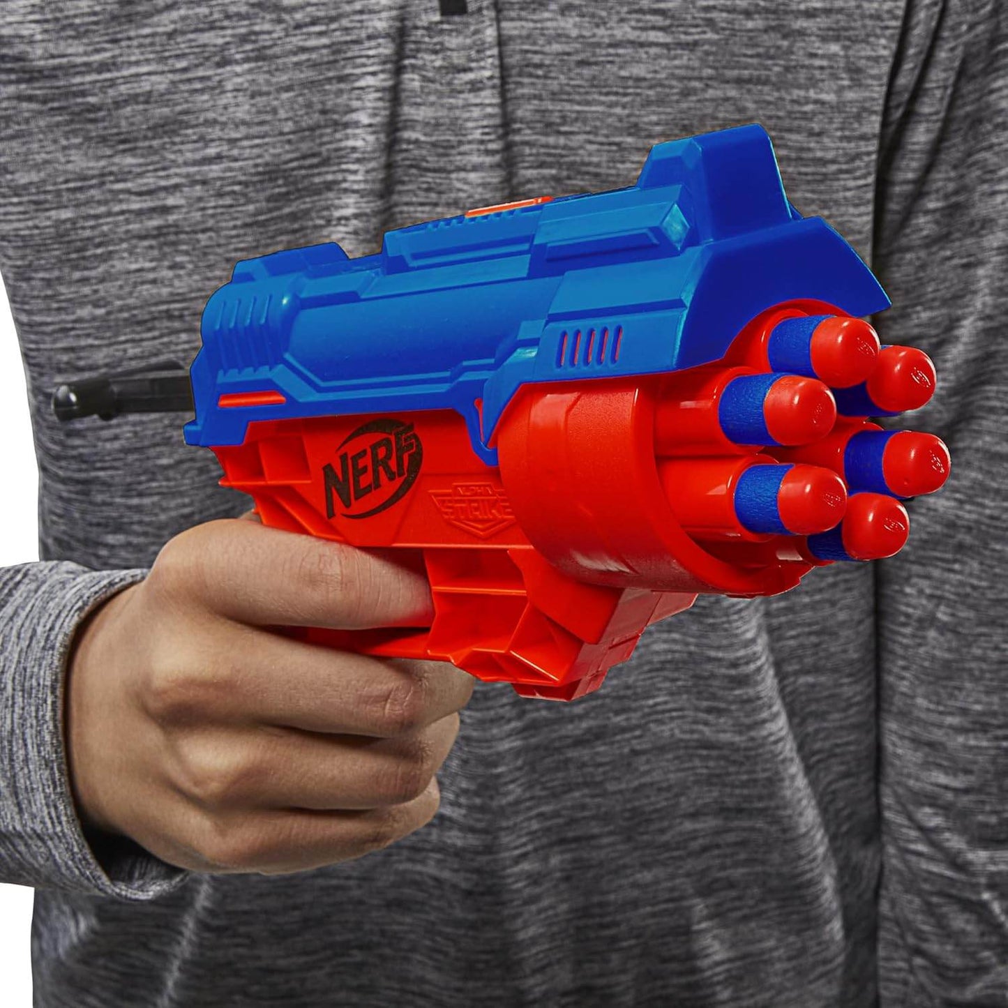 Hasbro Nerf Alpha Strike blaster in blue and red with foam darts loaded held by person in gray shirt