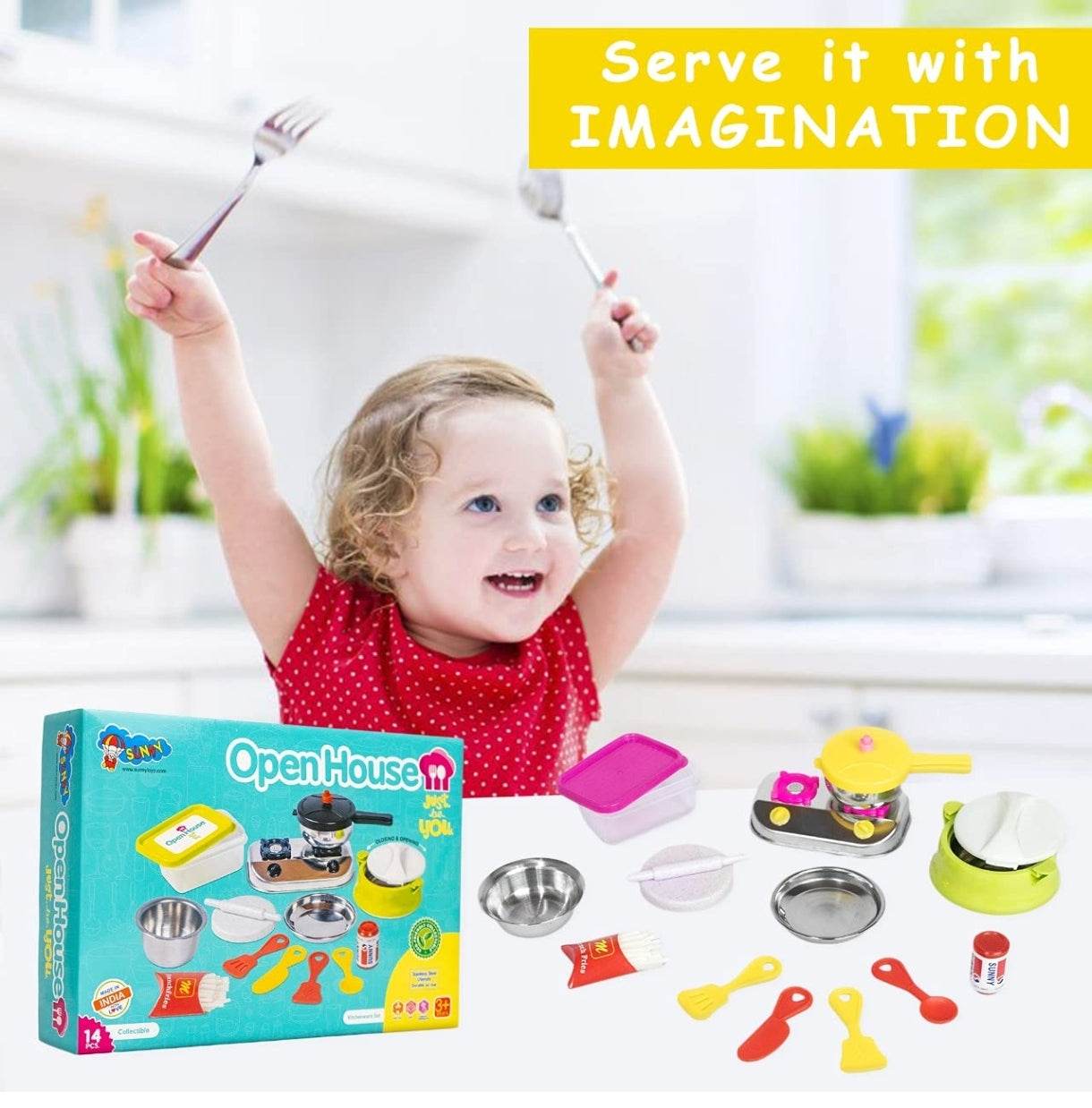 Happy toddler playing with kids kitchen set stainless steel toy cookware and utensils in a bright kitchen