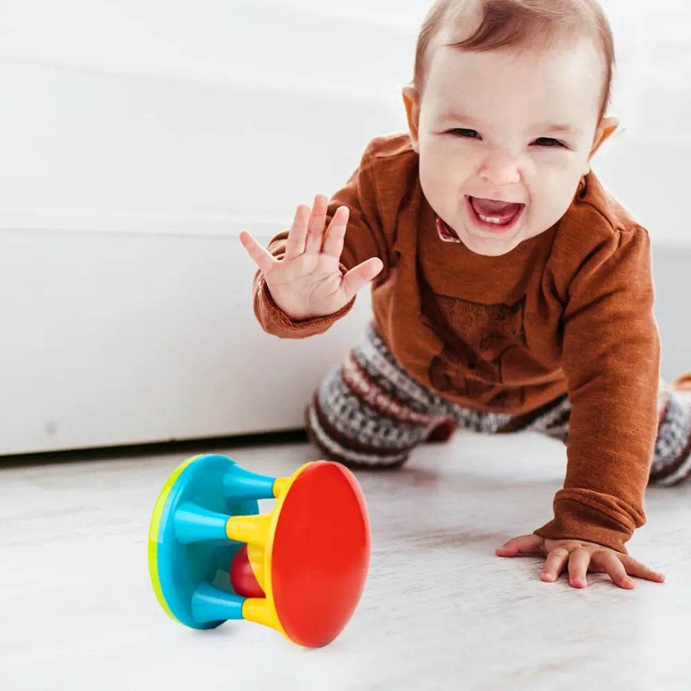 Happy baby playing on floor with colorful Ratnas musical roller for babies toy