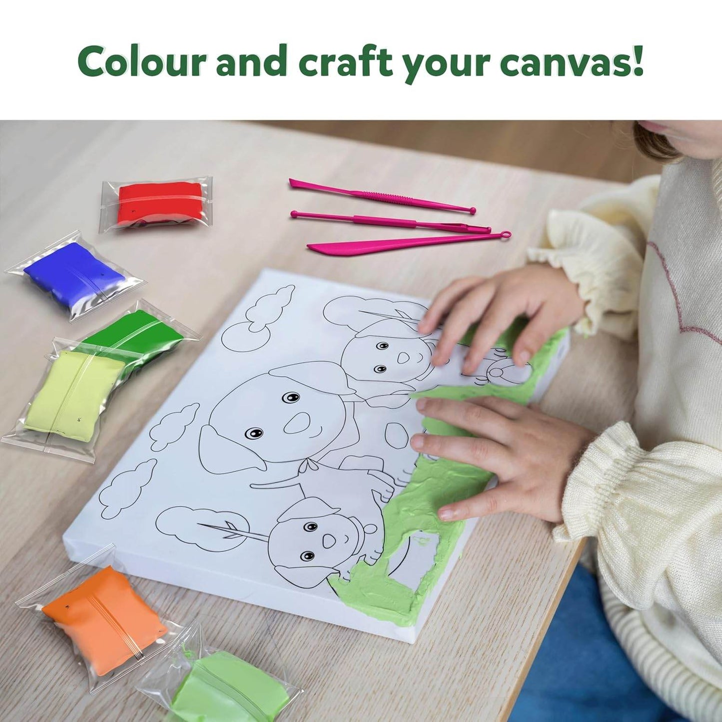 Child using colour with clay set for children to craft and color a dog-themed canvas art project