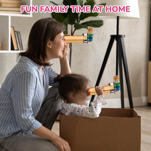 Mother and child playing with colorful kaleidoscope toy for kids at home during family time