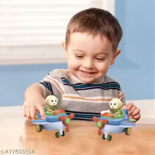 Child playing with toy planes on a wooden surface