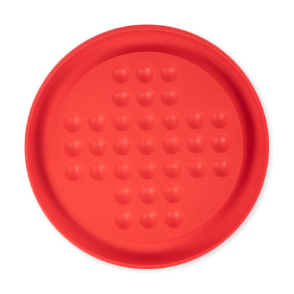 Red silicone trivet with textured surface on a white background