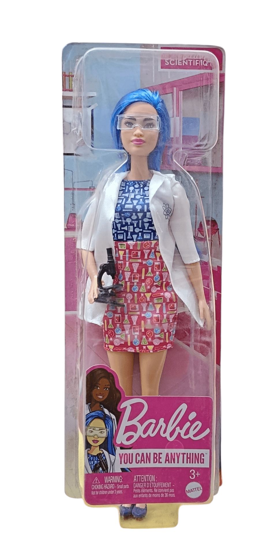 Barbie scientist doll with blue hair wearing lab coat and holding a microscope toy