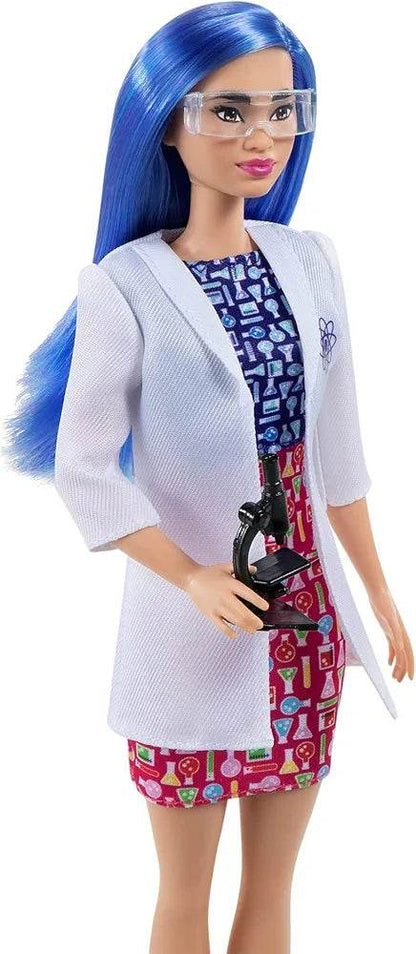 Barbie scientist doll with blue hair wearing safety glasses, white lab coat, and holding a microscope