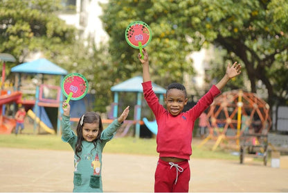 Kids playing with colorful bubble wands outside while learning how to make bubble solution