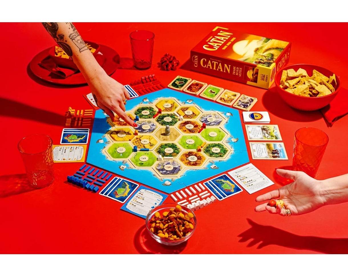 Catan board game with colorful hexagonal game board and player pieces for ages 10 and up