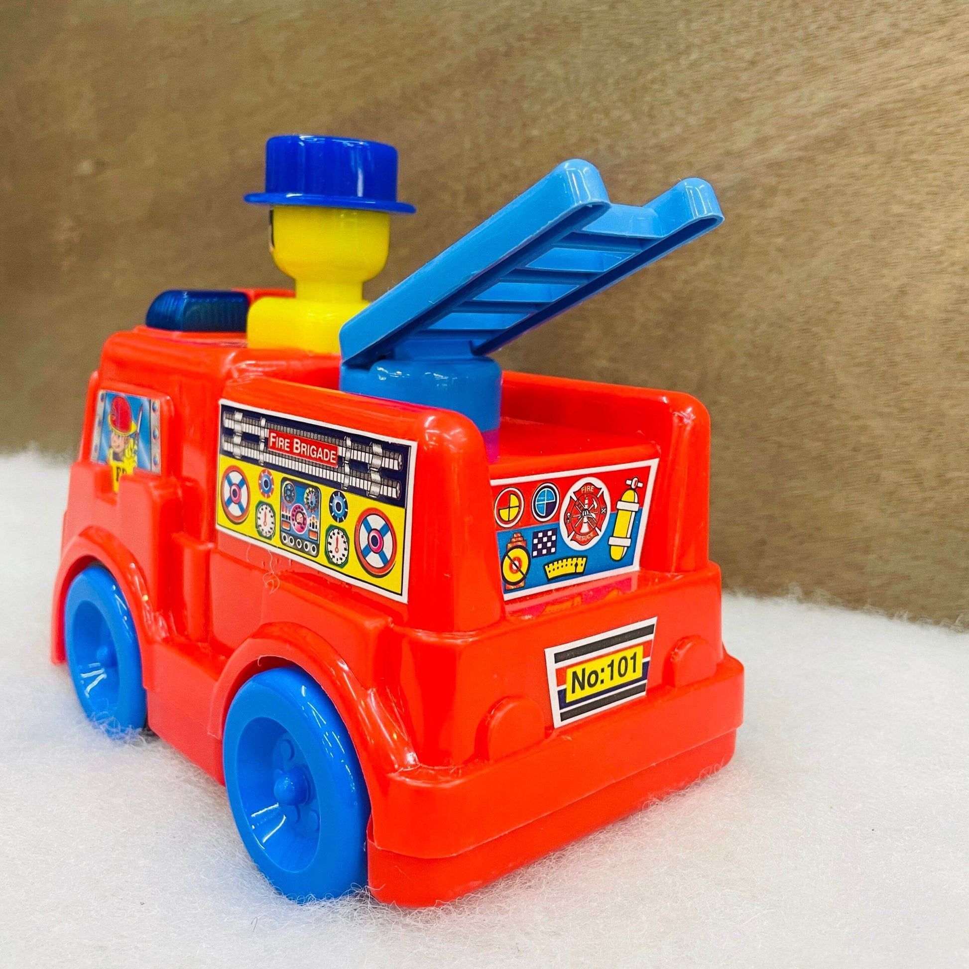 Bright red and blue push and go fire truck toy with ladder and colorful firefighter decals