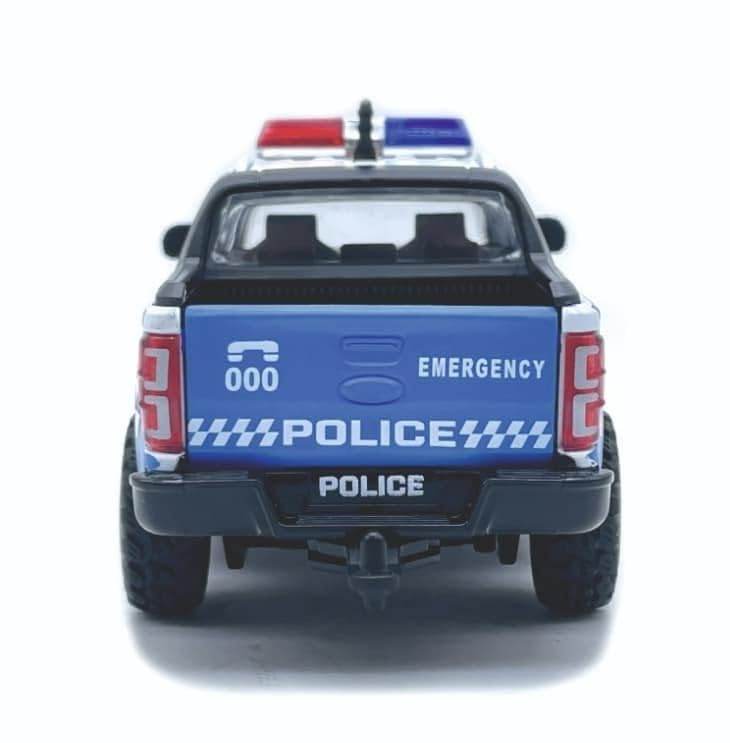 Rear view of blue police pickup truck toy with emergency lights and detailed police markings