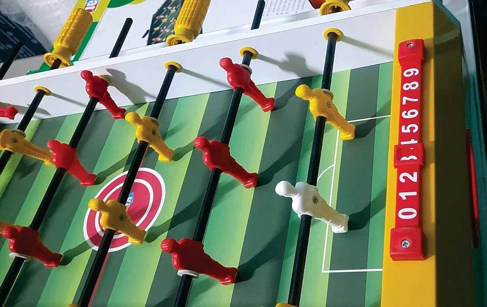 Kirat kids indoor football table game with red and yellow player figures on green striped field