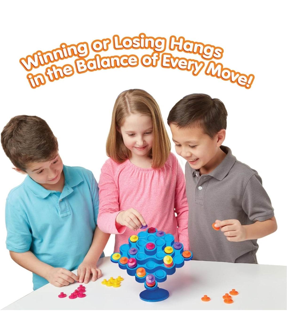 Colorful board game with children ages 5-8 balancing pieces on a tree structure
