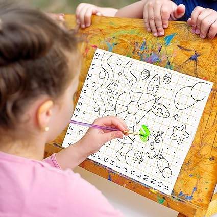 Child using kids canvas painting kit with paintbrush to color a pre-drawn sea-themed design on canvas