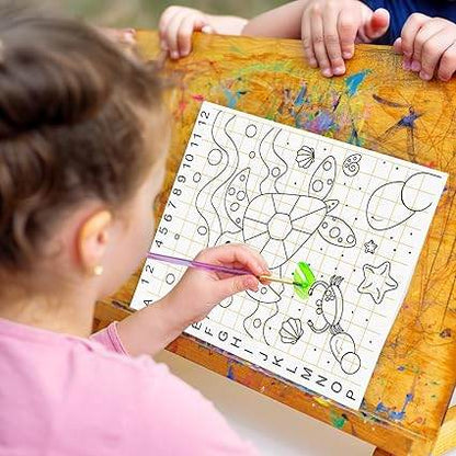 Child using kids canvas painting kit with paintbrush to color a pre-drawn sea-themed design on canvas