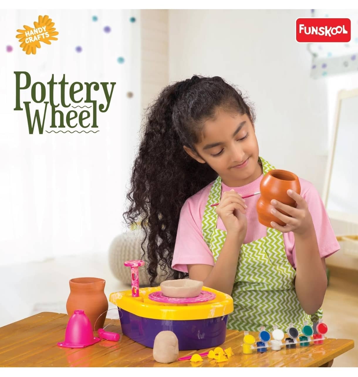Colorful pottery wheel for kids crafting pottery, perfect for age 5 and up, with girl painting a clay pot