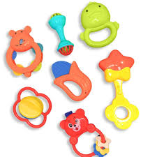 Set of colorful baby toys including teething rings and rattles on a white background