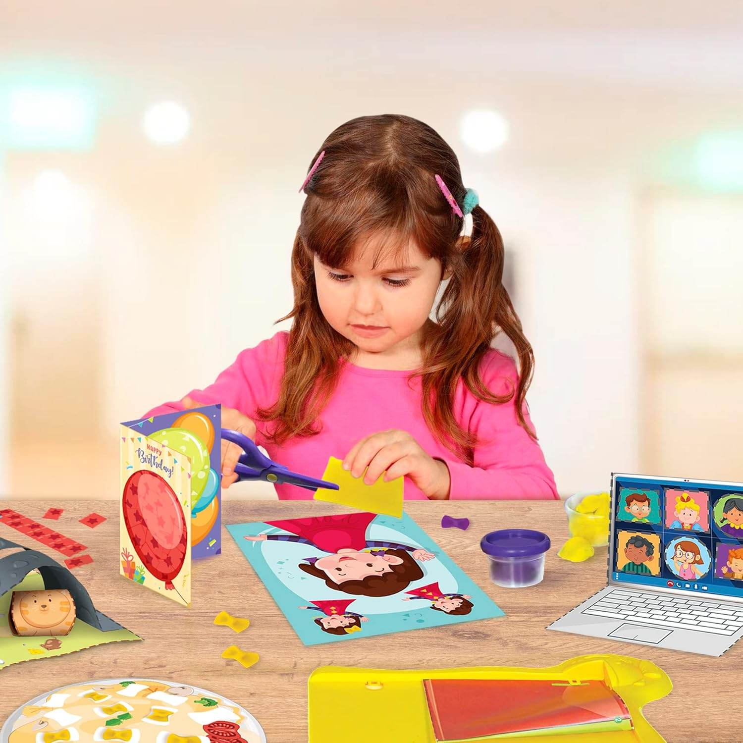 Young girl using scissors to work on a kids DIY craft kit with colorful paper and play clay on a table