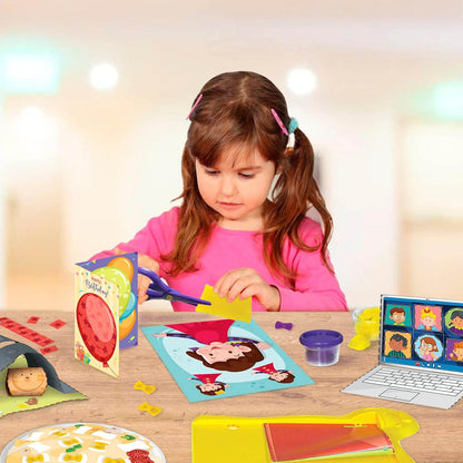 Young girl using scissors to work on a kids DIY craft kit with colorful paper and play clay on a table