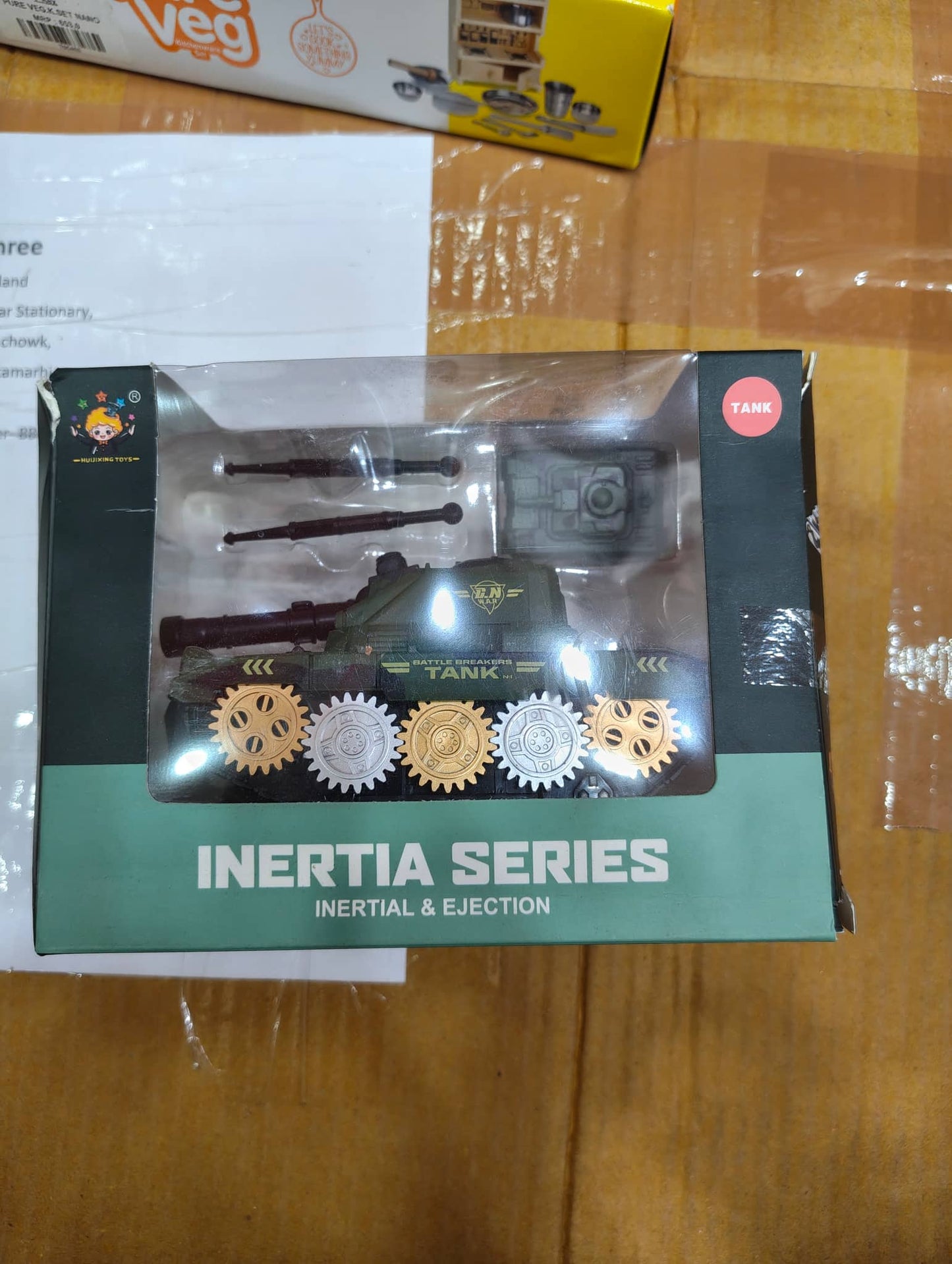 Green inertia tank toy with moving wheels, perfect for ages 3-5, featuring underground storage tank design