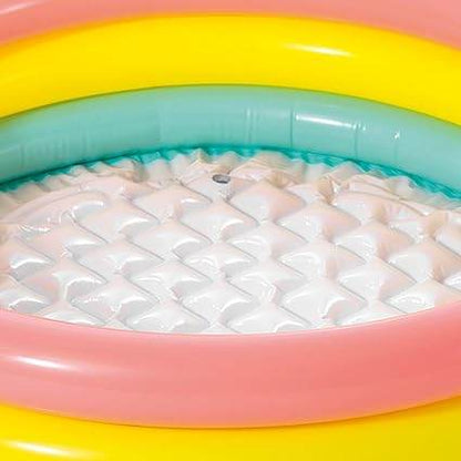 Colorful inflatable in pool for toddlers featuring bright pink, yellow, and green rings