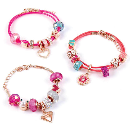 DIY charm bracelet kit for kids featuring colorful beads and heart and flower charms on adjustable pink bracelets