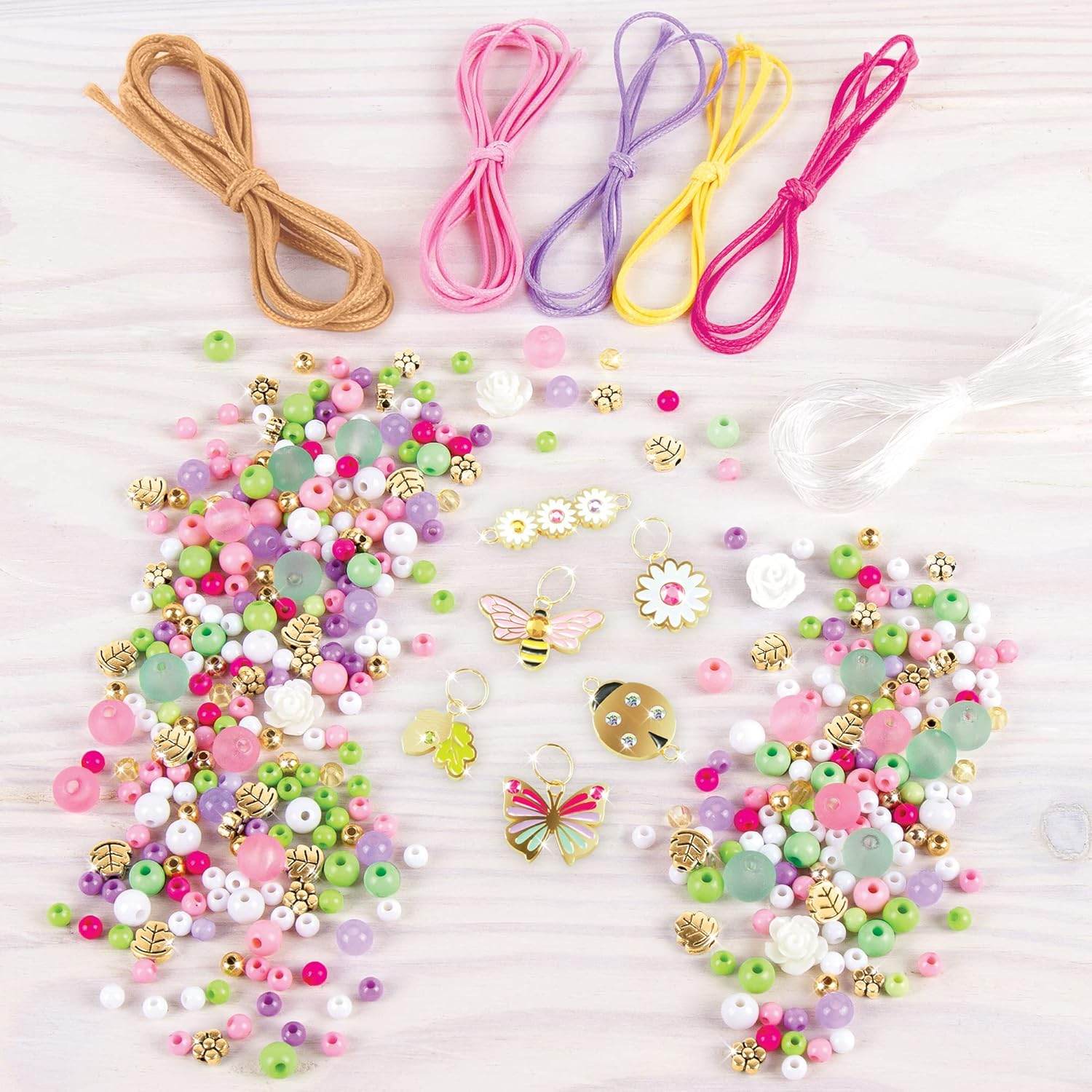 DIY jewelry kit for kids with colorful beads, strings, and butterfly and bee charms for creative crafting