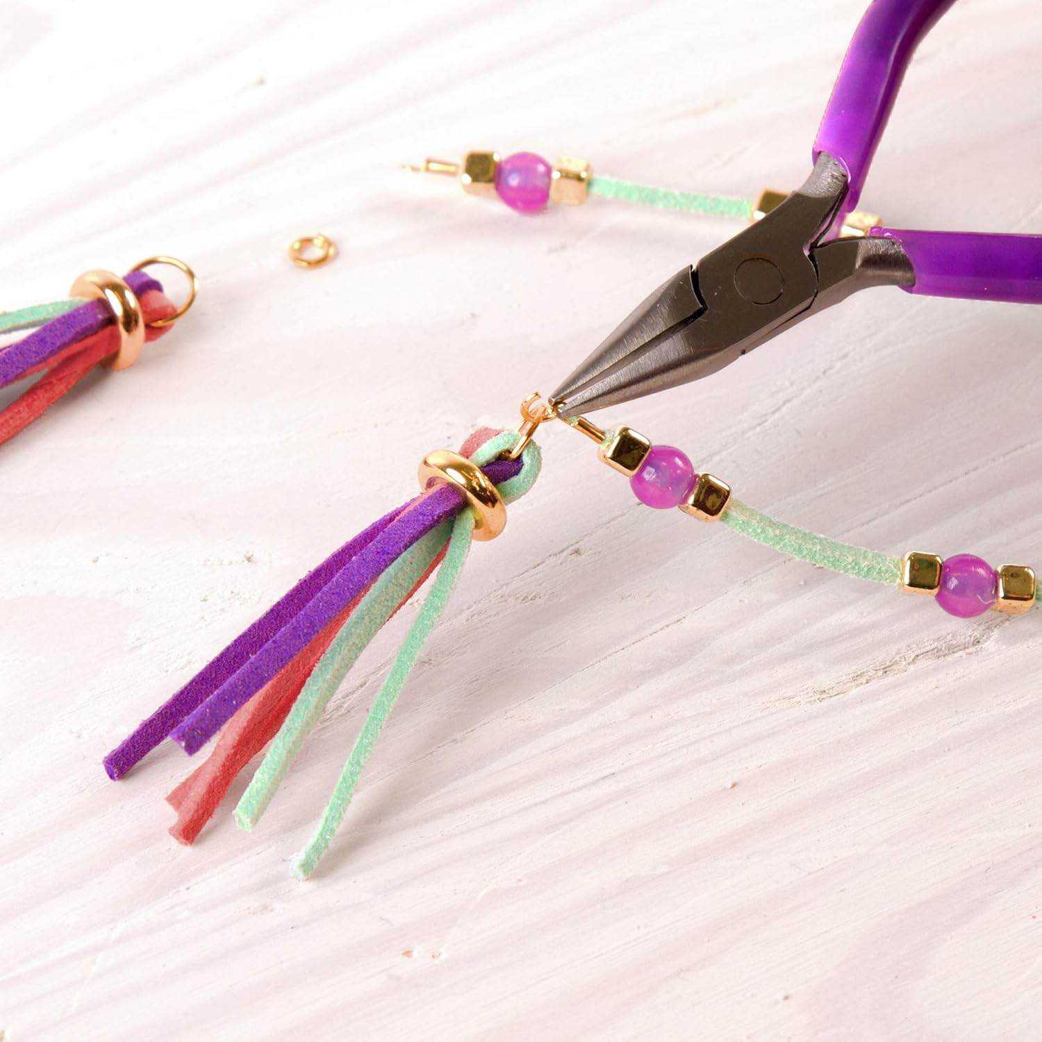 Close-up of tools and colorful beads used from the kids jewelry making set 112 pieces for crafting bracelets